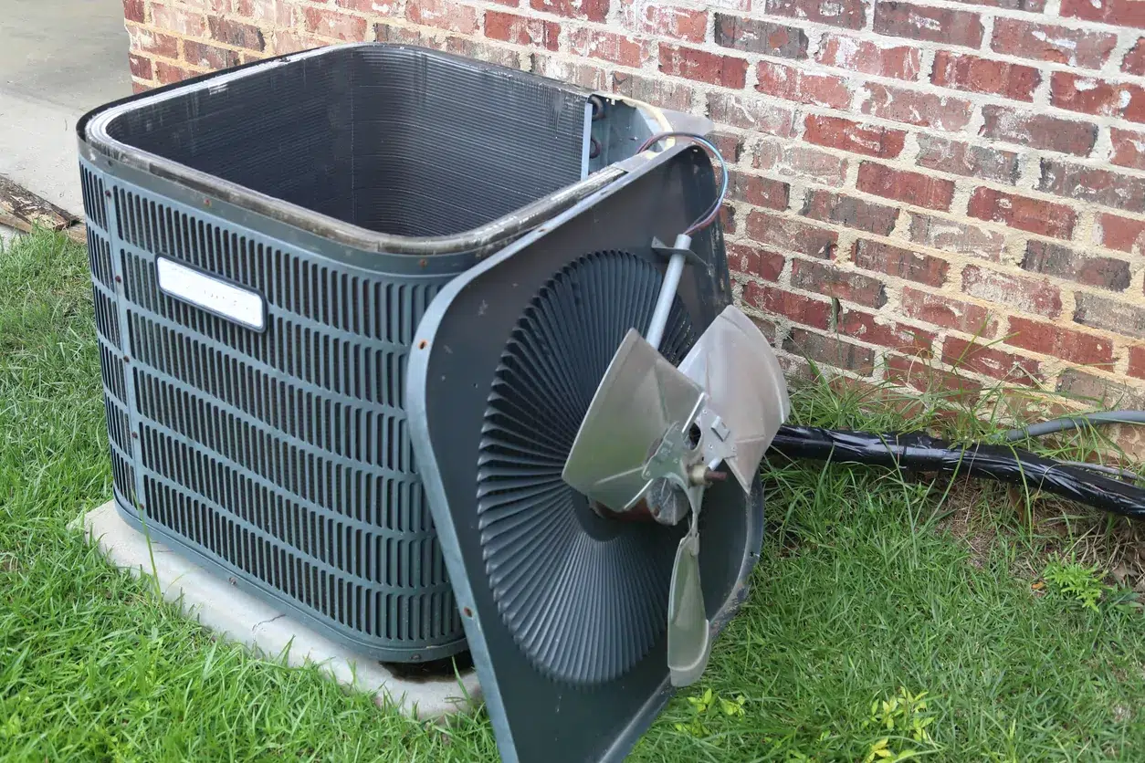 outdoor AC unit undergoing maintenance