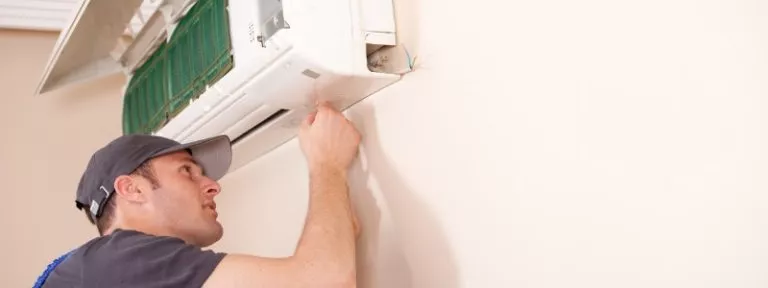 HVAC technician repairing ductless mini-split indoor unit