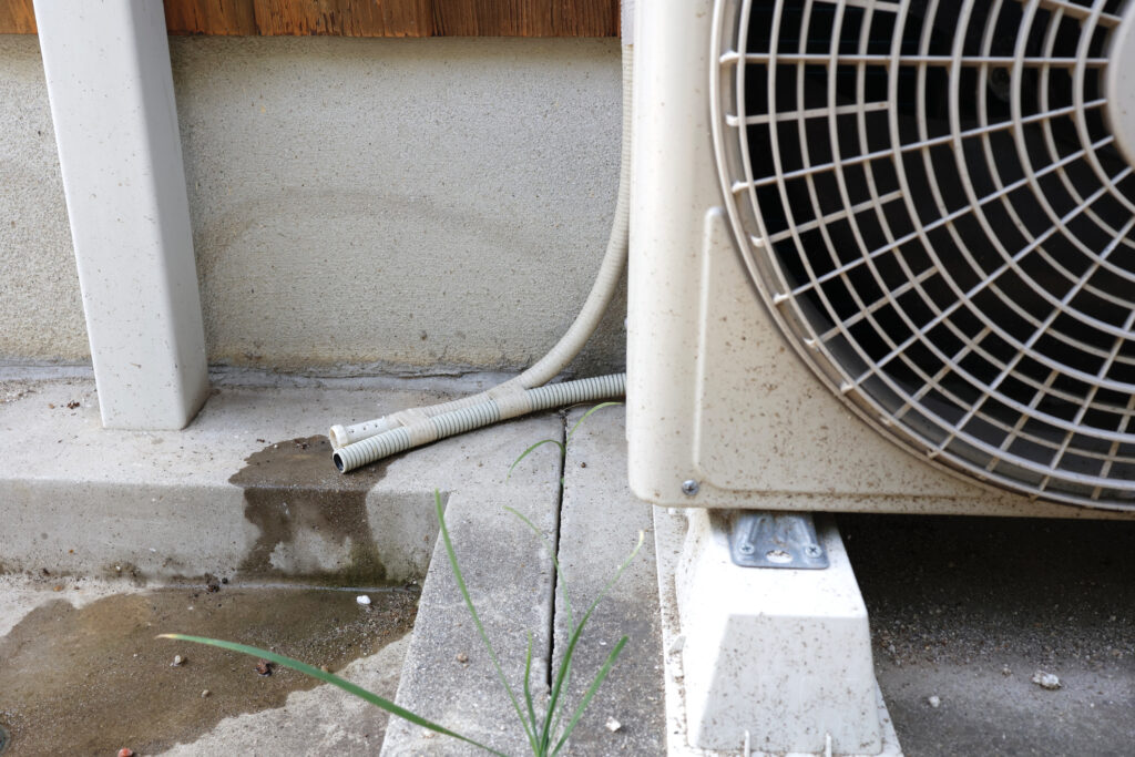 Drainage piping for condensed water attached to an air conditioner.