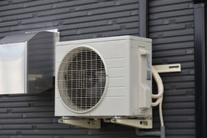 Ductless mini split outdoor unit installed on home's exterior.