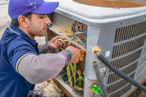 Andreas HVAC tech installing new air conditioner.