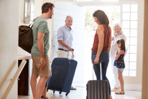 Family leaving on vacation with suitcases.